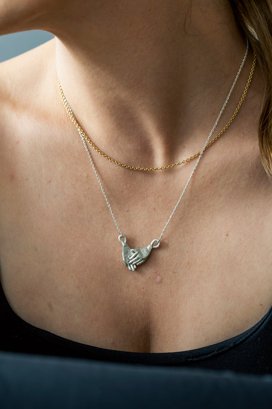 Holding hands necklace