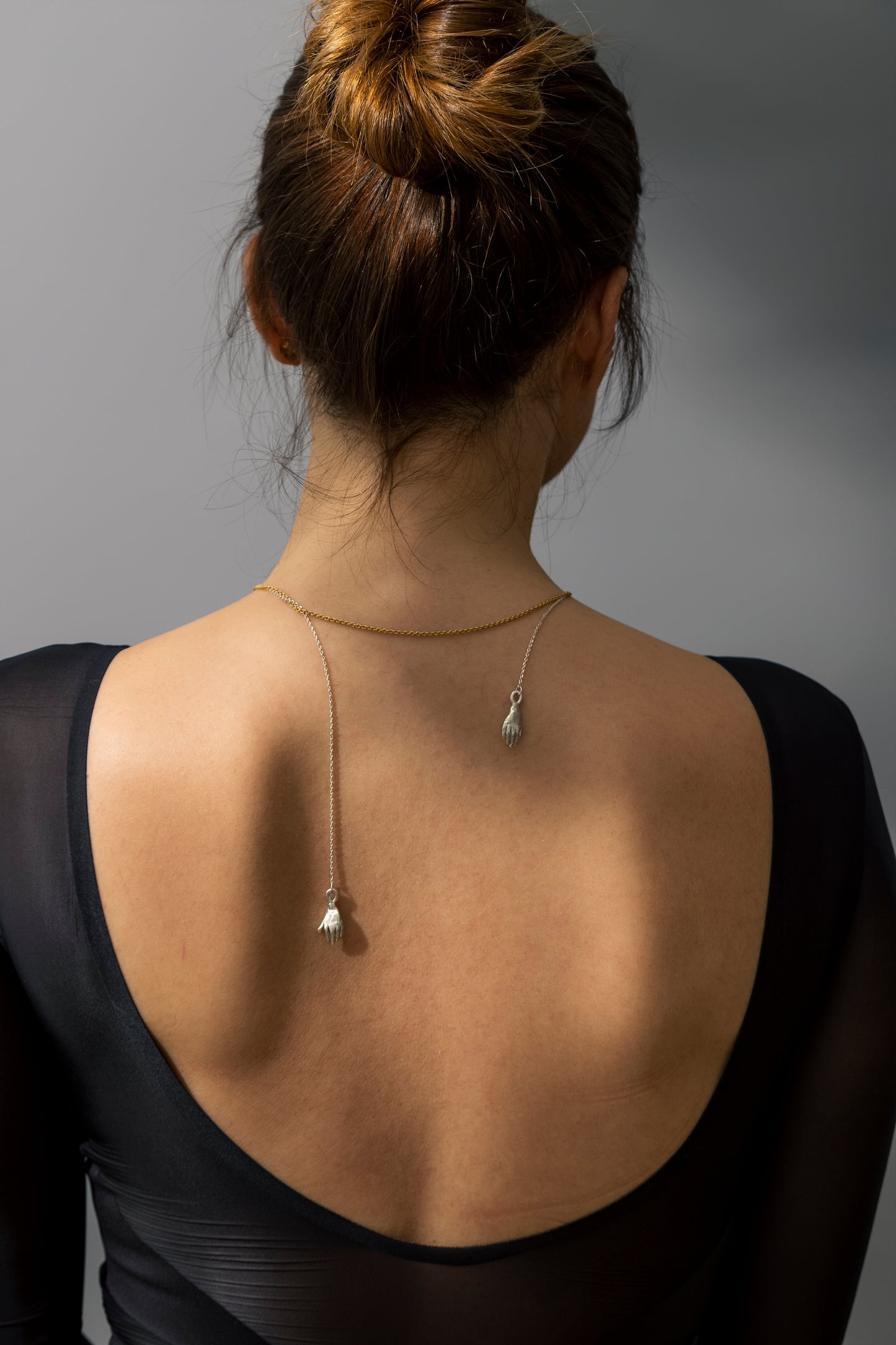 Holding hands necklace