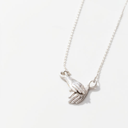Holding hands necklace